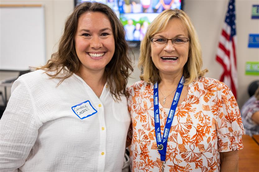 A PTO president smiles with a school principal